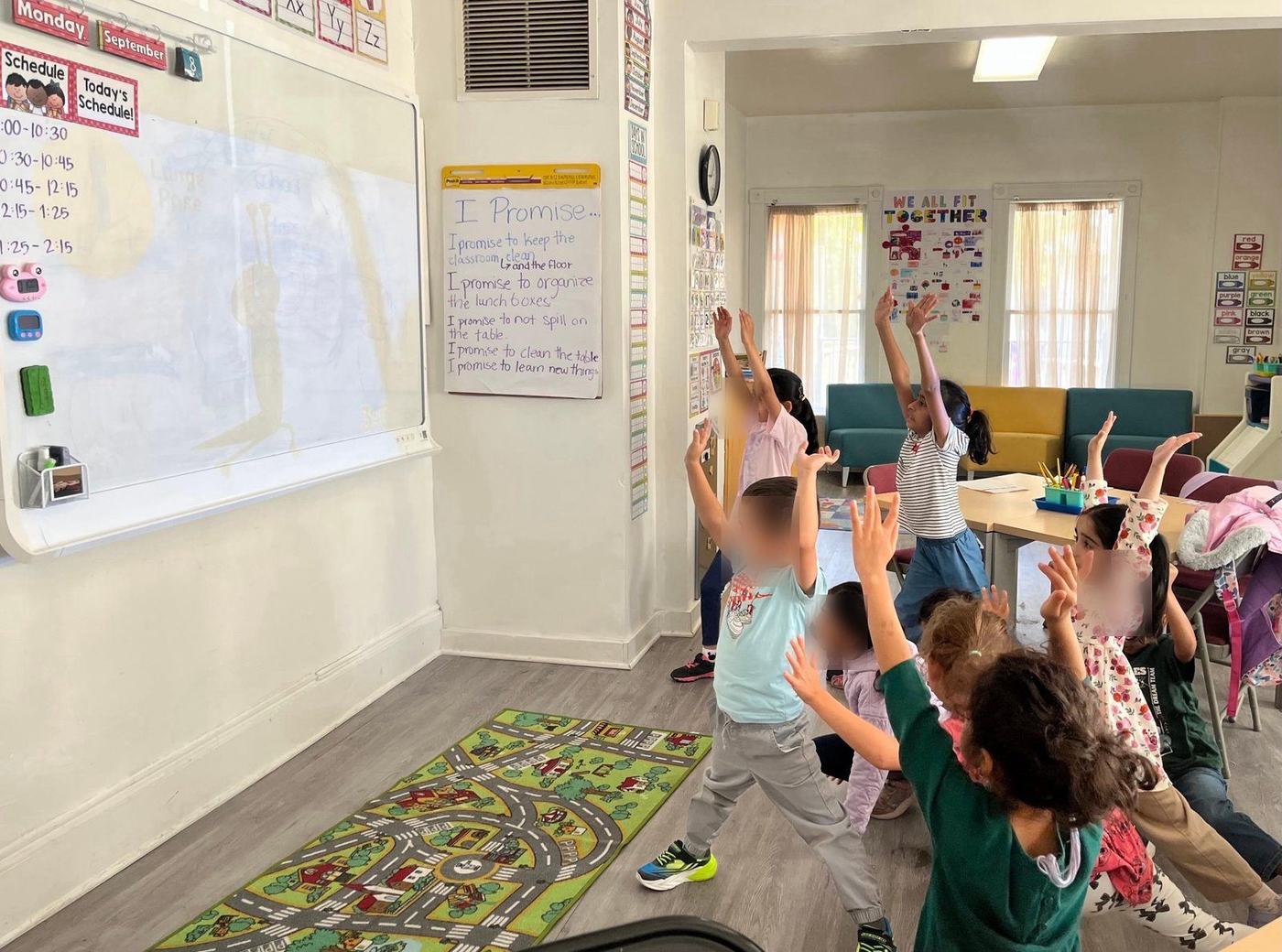 Children stretching together during a movement activity