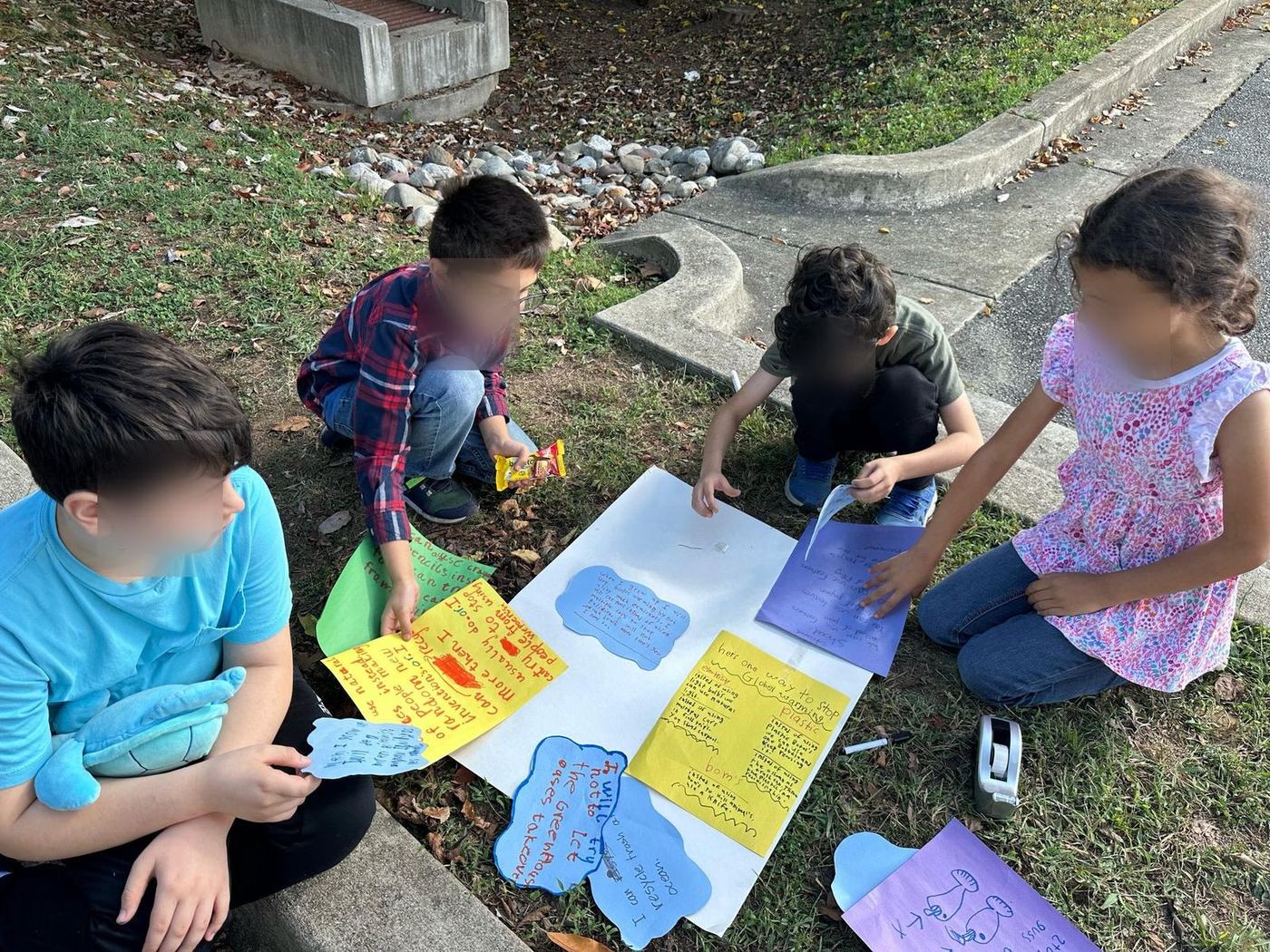 Students assembling a research poster project outdoors